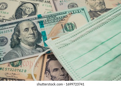 Face Mask On US Dollar Bill Banknote Background. Global Novel Coronavirus (Covid-19) Outbreak Effect To World Economy, Financial Crisis, Investment, Stock Market. Coronavirus Spread To China, US, EU.