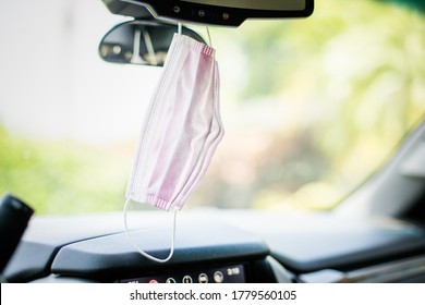 Face Mask PPE In Car Hanging From Rear View Mirror