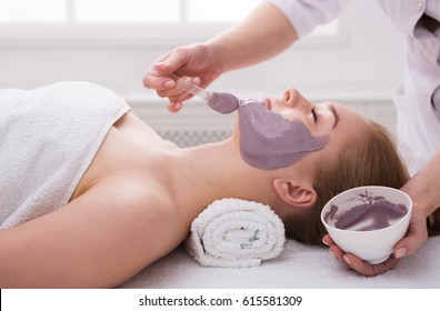 Face Mask, Spa Beauty Treatment, Skincare. Woman Getting Facial Nourishing Mask By Beautician At Spa Salon, Side View, Close-up