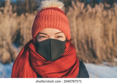 Face Mask Wearing Asian Woman Portrait In Outdoor Winter. Girl In Cold Weather Accessories, Hat, Scarf For Frost Bite.