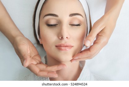 Face Massage. Spa Skin And Body Care. Close-up Of Young Woman Getting Spa Massage Treatment At Beauty Spa Salon. Facial Beauty Treatment.