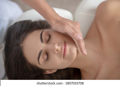 Face massage. Young pretty woman having face massage in the salon