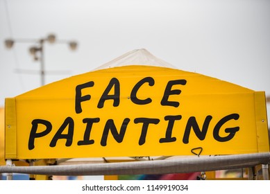 Face Painting Sign At County Fair Booth Trying To Attract Customers.