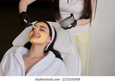 Face Peeling Mask, Spa Beauty Treatment, Skincare. Woman Getting Facial Care By Beautician At Spa Salon