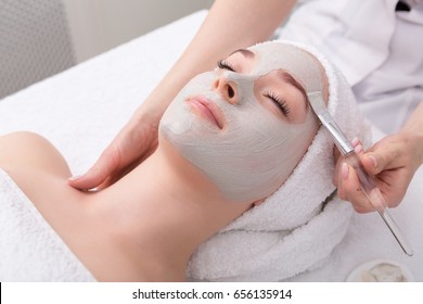 Face Peeling Mask, Spa Beauty Treatment, Skincare. Woman Getting Facial Care By Beautician At Spa Salon, Side View, Close-up