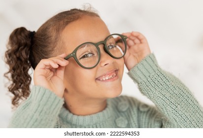 Face portrait, child and girl with glasses for optical health at optometrist office. Eyes wellness, eye care and happy kid with specs, spectacles or prescription lenses to help with ocular vision.