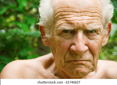 face portrait of an old angry frowning senior man