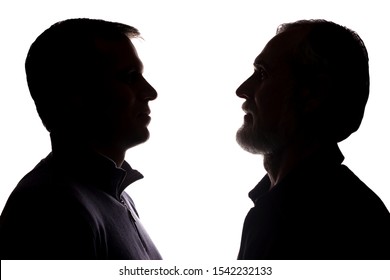 Face portrait of an old father and adult son opposite each other - silhouette, close-up family, generation