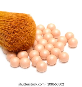 Face Powder Pearls (Ball-Powder) and Make-up Brush on White Background