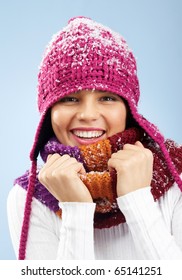 Face Of Pretty Woman In Knitted Winter Cap And Scarf Looking At Camera With Smile