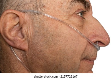 Face Profile Of Old Man With Nasal Cannula In Nose For Deliver Supplemental Oxygen And Respiratory Help.