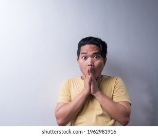 Face reaction, Asian young man portrait of face expression, shocked, thrilled, scared, surprised, with covered face with hand. Isolated, selective focus, copy space - Shutterstock ID 1962981916