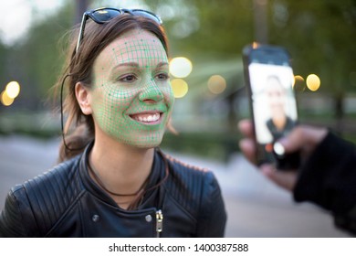 face recognition technology activated while taking a photo of a young woman with mobile phone