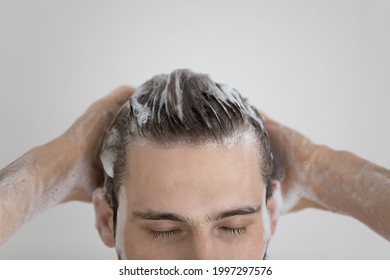 Face Of Relaxed Attractive Guy With Closed Eyes Washing Head In Foam With Shampoo For Dry Scalp Dandruff Treatment, Smooth Shining Hair, Taking Shower. Haircare, Bath Routine Concept. Close Up Shot