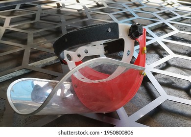 the face shield is placed on the workbench of the worker - Powered by Shutterstock