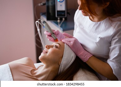 Face Skin Care. Closeup Of Woman Face Cleansing At Cosmetology clinic, vacuum cleaning
