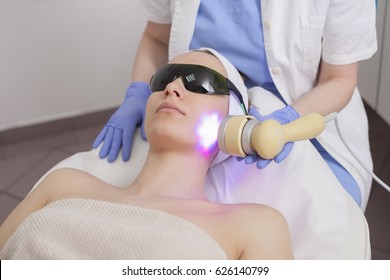 Face Skin Care. Woman Getting Facial Laser Treatment