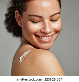 Face, skincare and back of woman with cream in studio isolated on gray background. Cosmetics, beauty dermatology and happy female model with lotion, creme or moisturizer for healthy skin or wellness. - Powered by Shutterstock