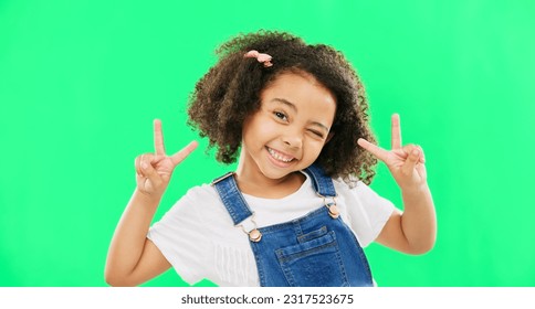 Face, smile and child with peace sign on green screen in studio isolated on a background. Portrait, emoji and wink of happy kid or girl with v hand gesture or symbol for happiness or joy. - Powered by Shutterstock