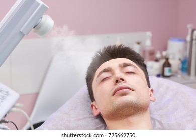 Face Steaming In Beauty Clinic. Healthy Young Man, Cosmetology.