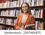 Face, student and woman in university in library ready for learning. Portrait, education and happy female from Brazil standing by bookshelf with book for studying, knowledge and literature research.