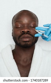 Face Treatment. Male Injection. Man Receives Anti Aging Skin Care. Beauty Cosmetology Procedure In Clinic. Beautician Hands In Gloves With Syringe.