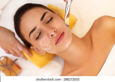 Face Treatment. Woman In Beauty Salon Gets Marine Mask