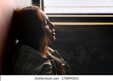 Face upset young woman brown hair standing alone at windows while closing her eyes and thinking something. Loneliness businesswoman depression and sadness. - Powered by Shutterstock