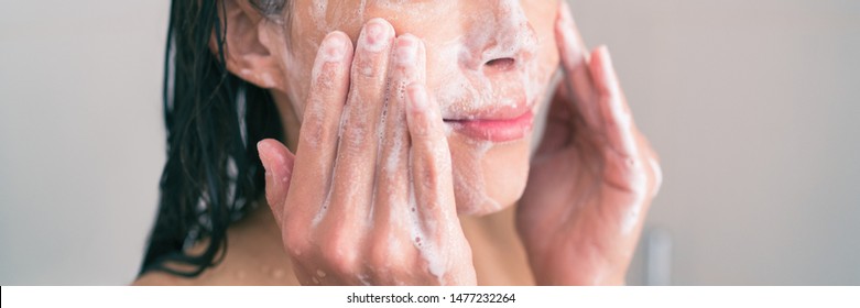 Face wash exfoliation scrub soap woman washing scrubbing with skincare cleansing product panoramic banner. - Shutterstock ID 1477232264