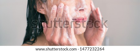 Face wash exfoliation scrub soap woman washing scrubbing with skincare cleansing product panoramic banner.