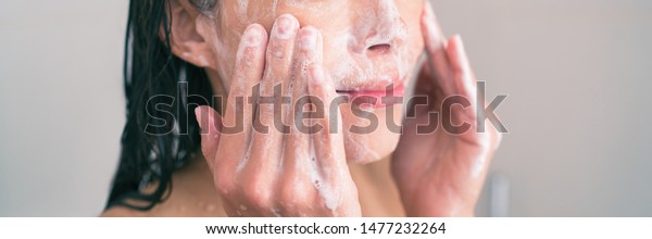 Face wash exfoliation\
scrub soap woman washing scrubbing with skincare cleansing product\
panoramic banner.