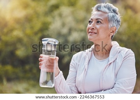 Face, water bottle and senior woman in nature on break after sports workout, exercise or training. Thinking, drinking water and retired female from India with liquid for hydration, health or wellness