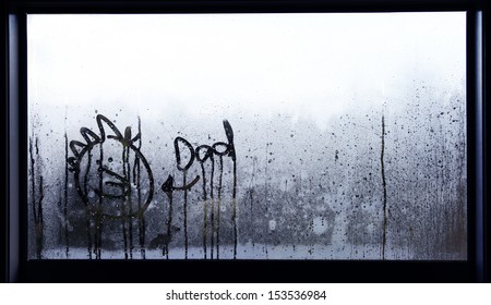 Face And Word Dad Drawn In Condensation On Window