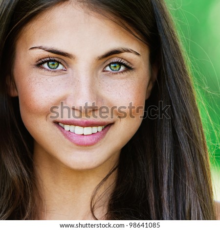 Face young beautiful girl dark closeups short hair summer park smiling
