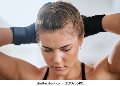 Face Of A Young Female Boxer Getting Ready To Train In The Gym For A Boxing Match. Sporty, Active And Healthy Athlete Tying Her Hair To Exercise. Motivated Woman Doing A Fitness Workout.