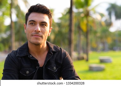 Face Of Young Handsome Hispanic Man Thinking In The Park