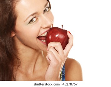 Face of young woman biting the red apple