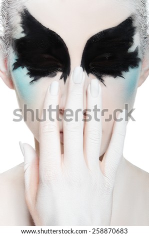 face of young woman with black and white makeup isolated on white
