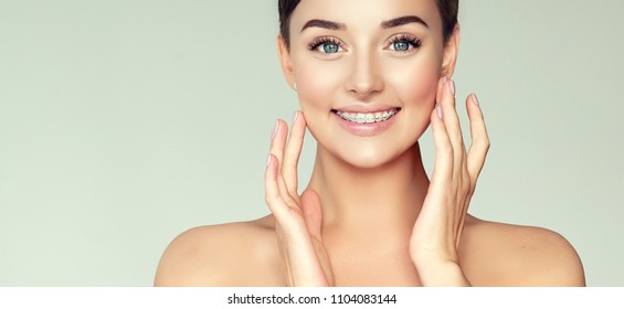 Face Of A Young Woman With Braces On Her Teeth . Healthy Smile 