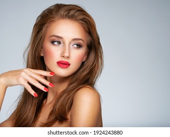 Face Of Young Woman With Red Nails, Lipstick And Long Brown Hair.  Portrait Of An Attractive Model. Girl With Bright Fashion Makeup