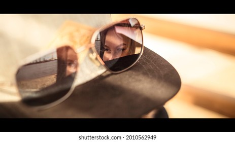 Face Of Young Woman In Sunglasses Reflection