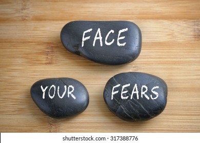 Face your fears, three words motivational slogan conceptual - Shutterstock ID 317388776