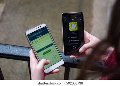 Facebook against snapchat, snapchat in the stock market. Two phones and a young girl with both apps.