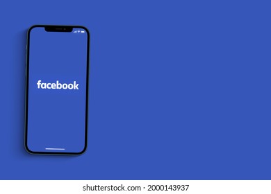 Facebook app on smartphone screen on blue background. Social media from the same group as Instagram and Whatsapp. Top view. Rio de Janeiro, RJ, Brazil. June 2021.