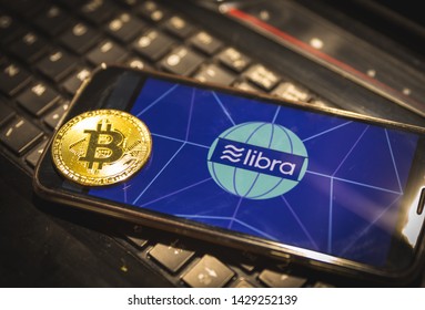 Facebook Cryptocurrency Libra’s Image On A Smartphone With A Bitcoin In Front Of The Libra’s Image Sydney Australia 20/06/2019