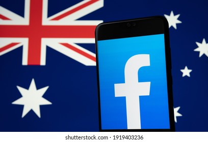 Facebook Logo Seen On The Smartphone And Blurred Australian Flag On The Background Screen. Concept For News Feed Ban In Australia. Stafford, United Kingdom, February 18, 2021.