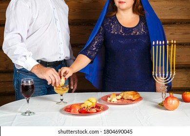 A Faceless Jewish Family, A Woman And A Man Dipping Challah In Honey At Rosh Hashanah.