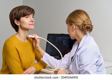 Faceless Medical Worker Conducting Thorough Scan Of Cervical Veins And Arteries, Examines Throat. Modern Devices For Ultrasound Diagnostics. Appointment Of Patient With Problems With Endocrine System