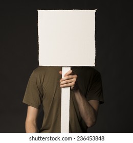 Faceless person holding a blank square sign