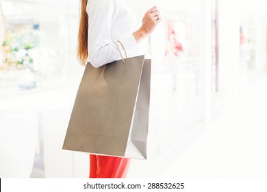 Faceless Photograph Of Woman Holding A Blank Paper Shopping Back (mock Up To Paste A Logo)